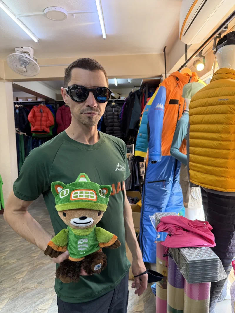 Nicholas trying on glacier goggles while holding Sumi