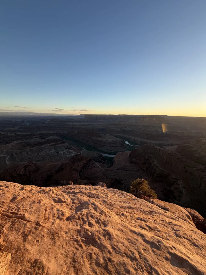 The Colorado River gooseneck far below Dead Horse Point at golden hour