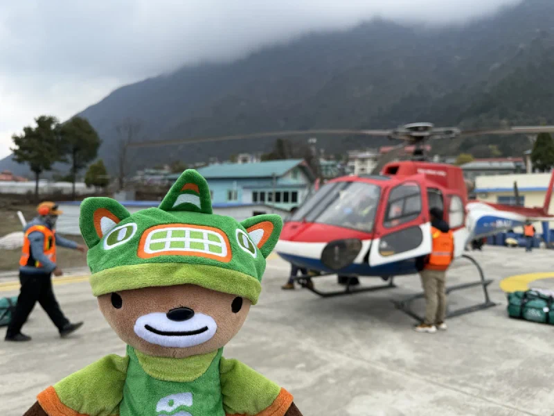 Sumi on the Lukla helipad with the Kailash helicopter behind