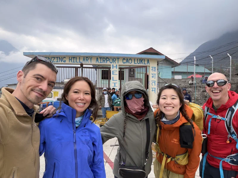 Group photo at the Tenzing-Hillary Airport gate: Nicholas, Pokin, Po On, Alice, and Steve