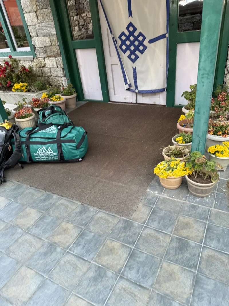 Lodge entrance with duffel bags staged outside