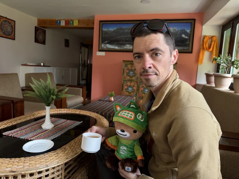 Nicholas and Sumi at a table with tea in the lodge lounge