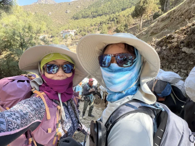 Pokin and Po On selfie on the trail in sun hats and face buffs
