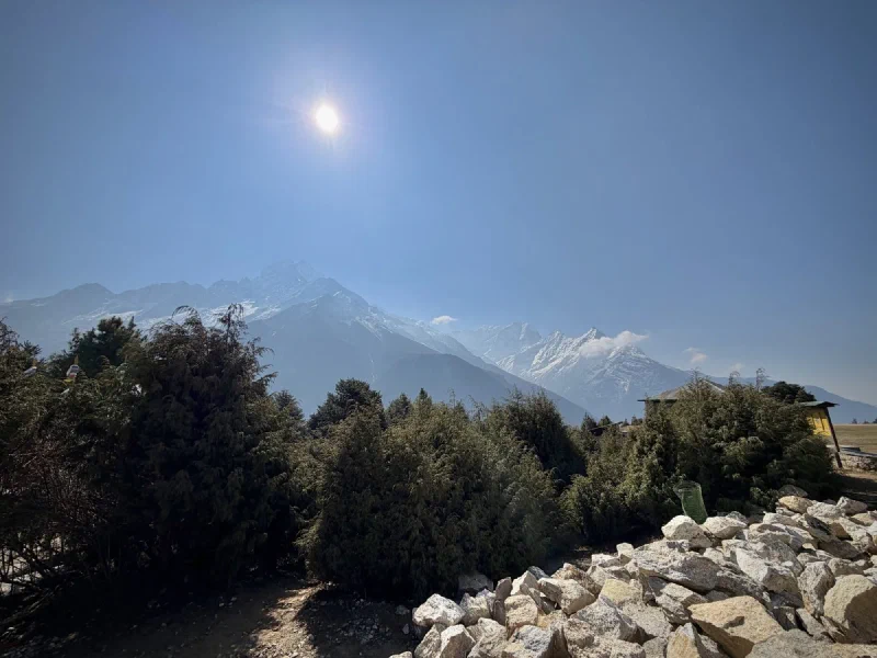 Mountain panorama from museum viewpoint with snow-capped peaks and bright sun