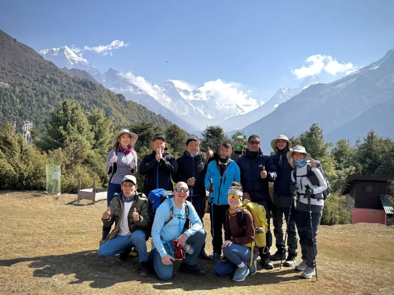 Group photo at viewpoint with Mount Everest and Lhotse visible in background