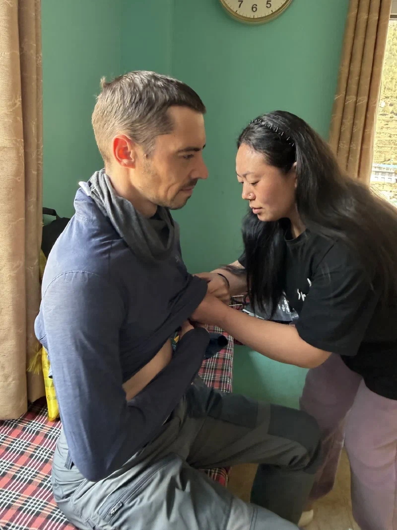 Doctor examining Nicholas in the clinic exam room