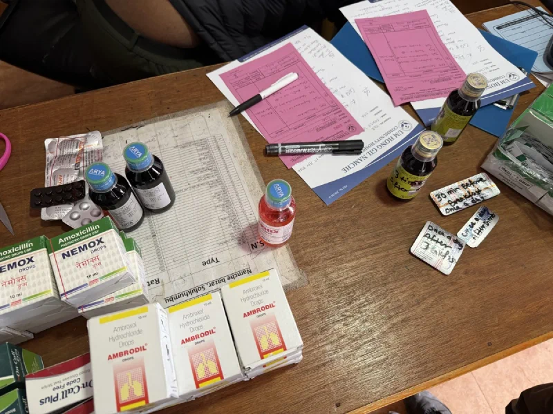 Desk covered in medication boxes and hospital forms from Um Hong Gil Namche Community Hospital
