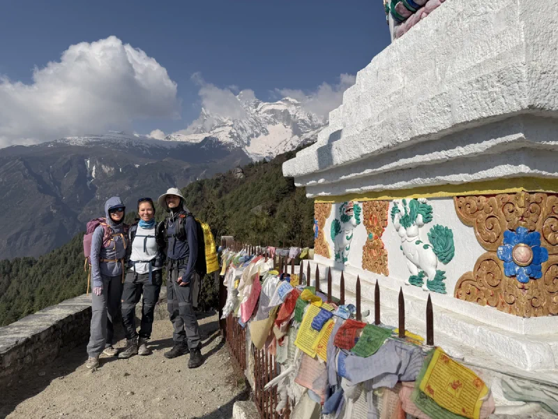 Po On, Pokin, and Nicholas on a stone wall
