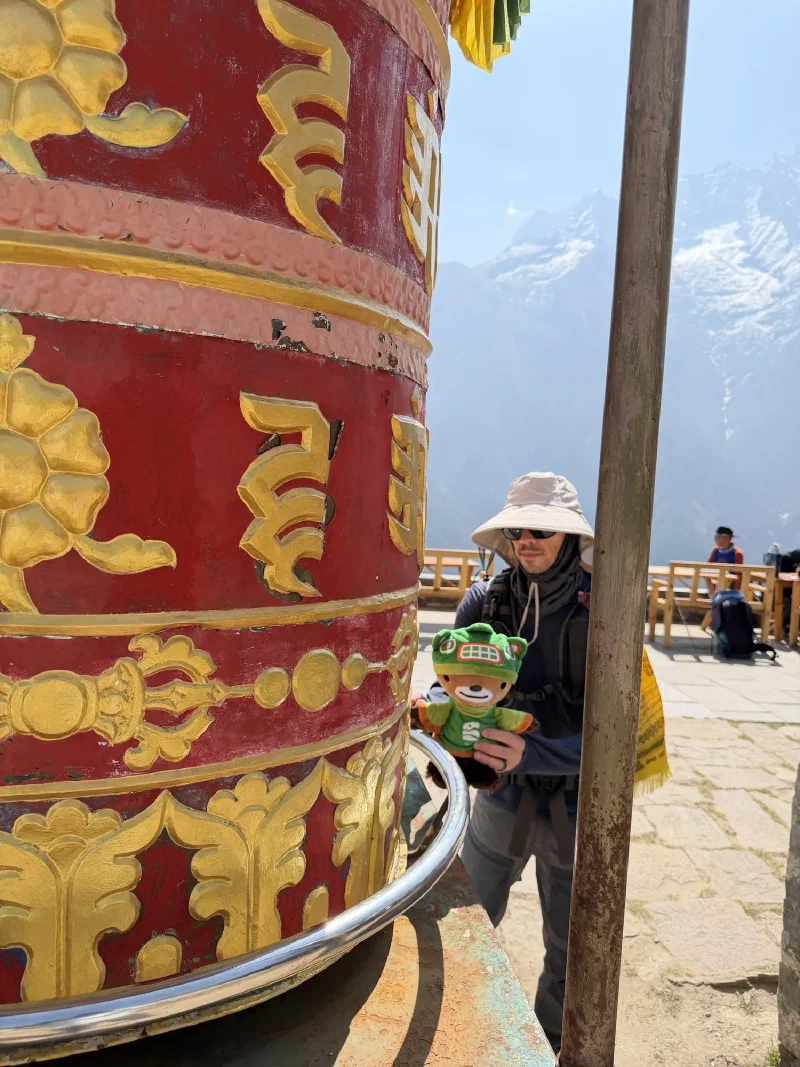 Sumi spinning a prayer wheel