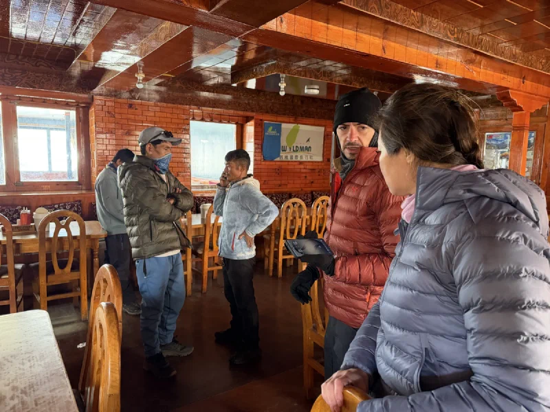 Nicholas and Pokin inside the lodge, planning the day ahead