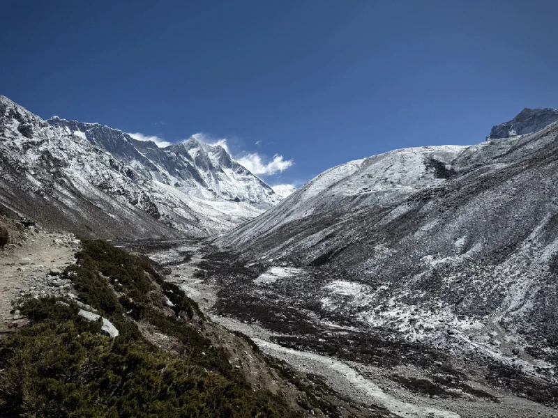 Wide view looking up the valley toward Lhotse with a braided riverbed below