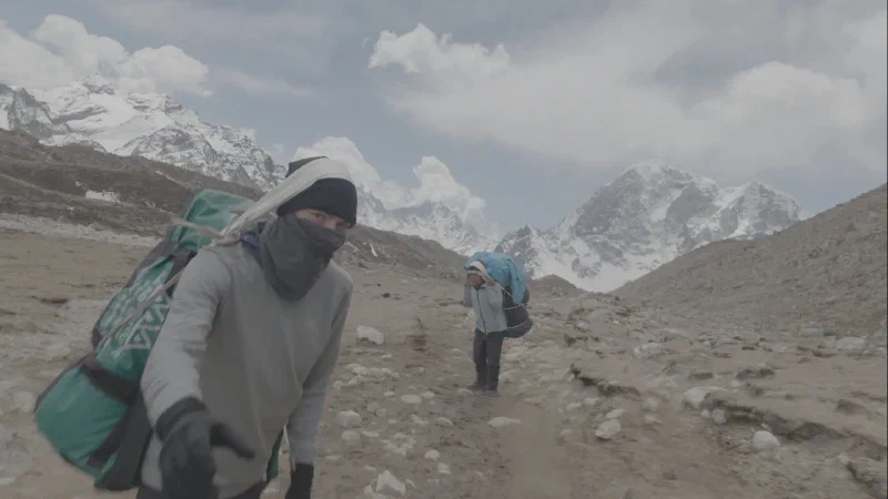 Nicholas carrying porter bag on the trail