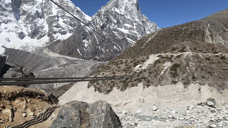 Steel cables strung across a gorge where a suspension bridge is being built near Thukla