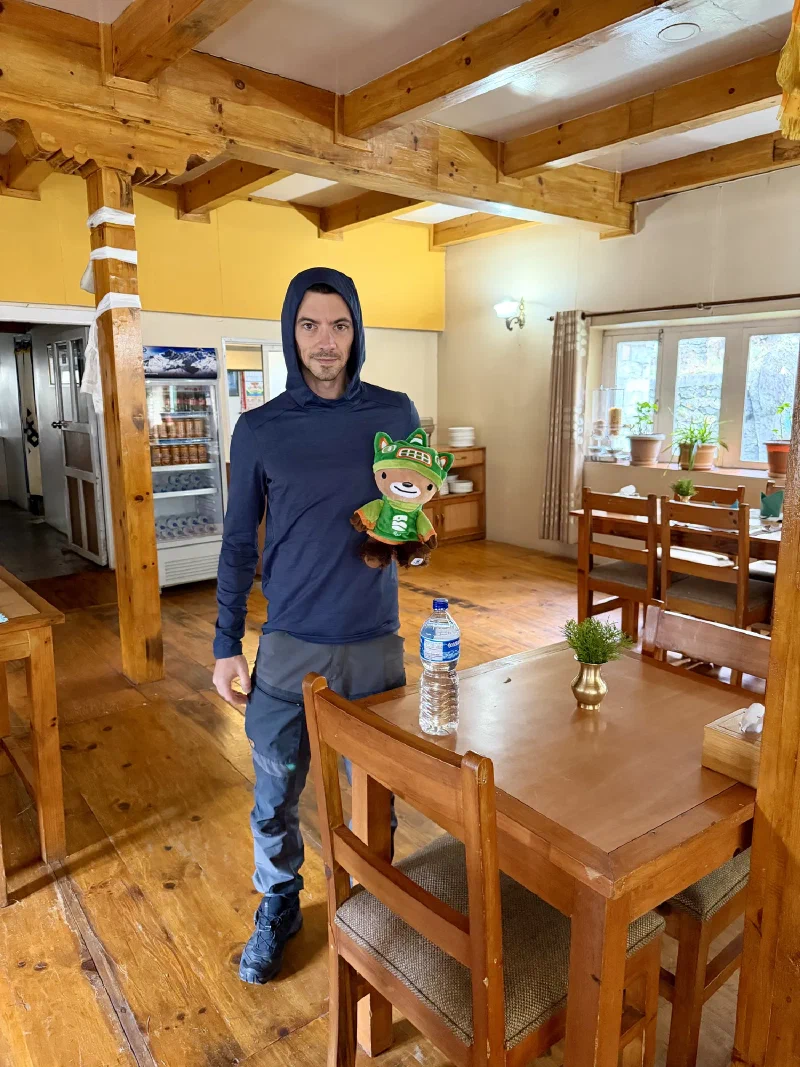 Nicholas holding Sumi in the lodge dining room before the hike