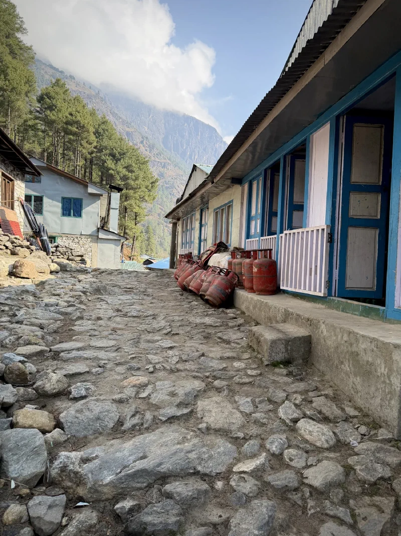 Stone trail through settlement with propane canisters