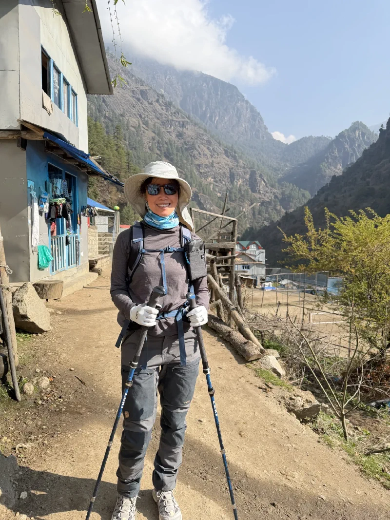 Pokin fully geared up on the trail with trekking poles and sun hat