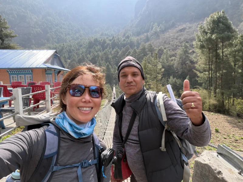 Pokin and Manoj selfie before a suspension bridge