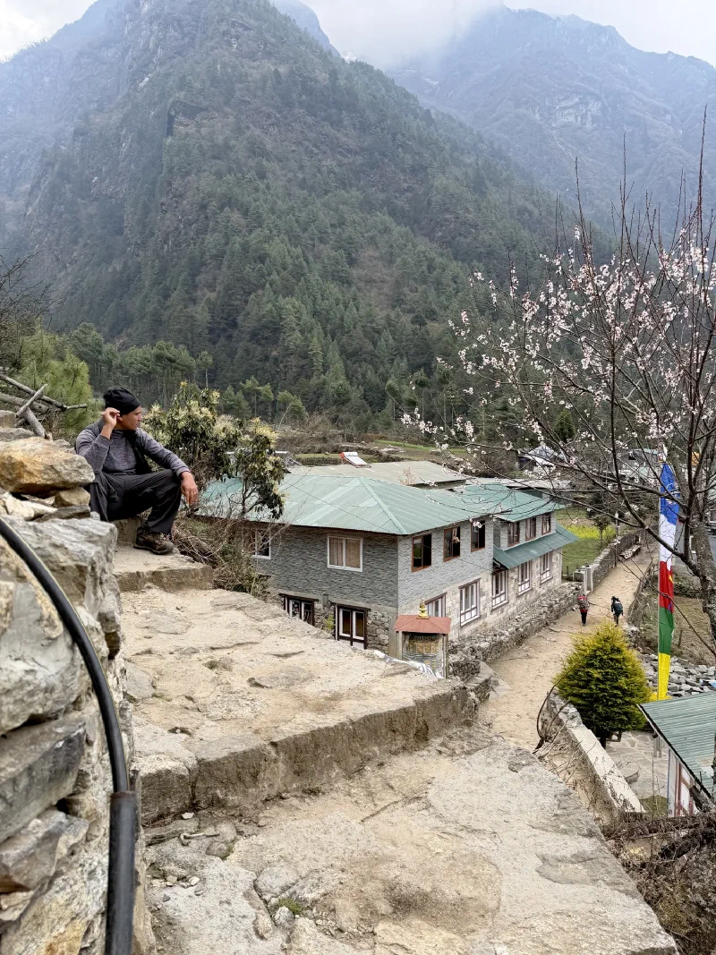 D.B. sitting on a stone ledge overlooking the valley