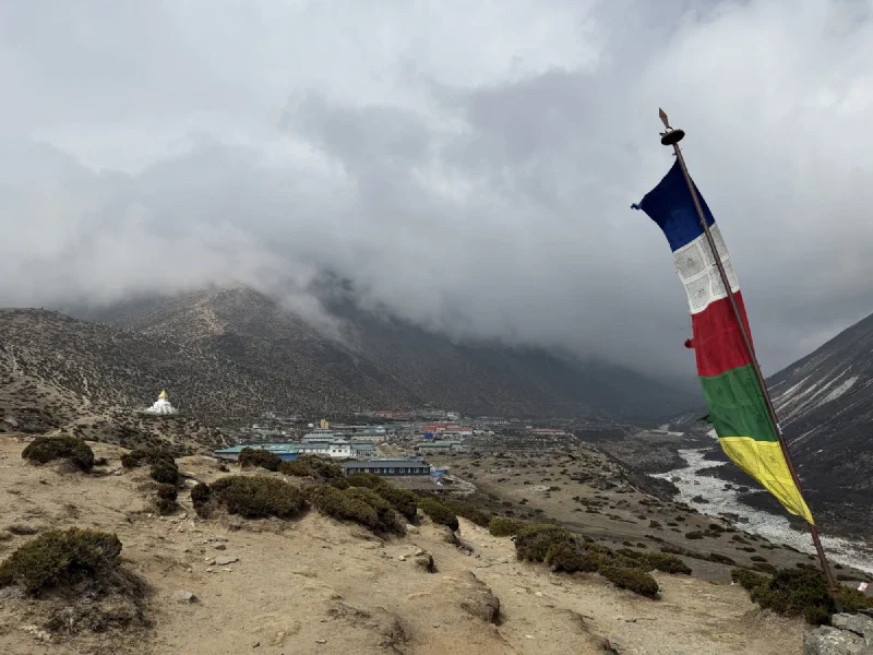 View of Dingboche village with prayer flag and stupa