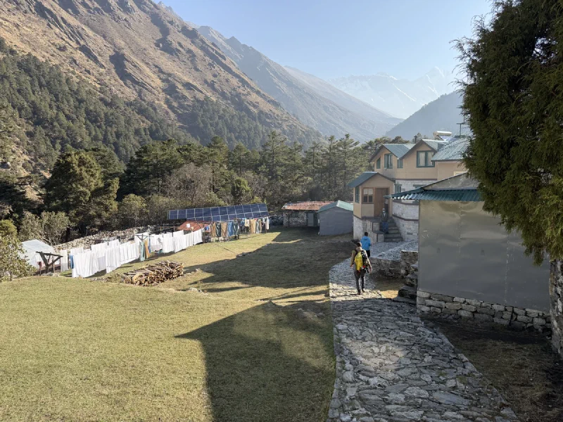 Deboche village with laundry lines, solar panels, and mountains