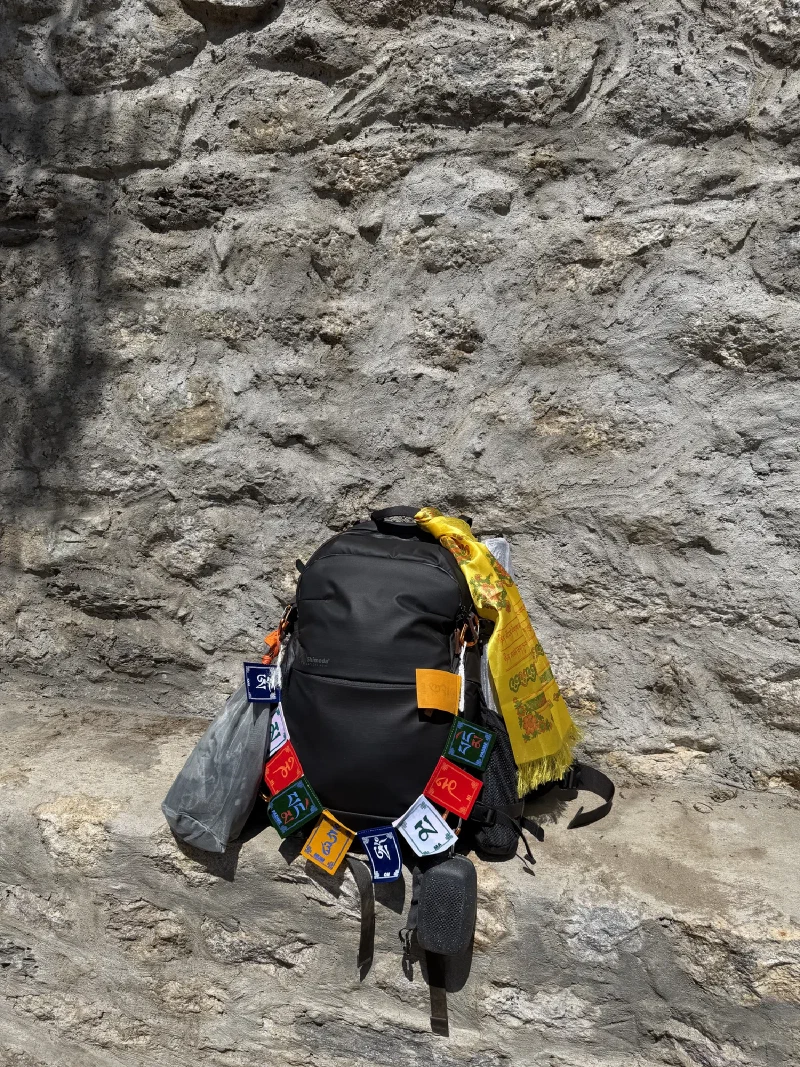 Nicholas's Shimoda backpack decorated with prayer flags and khata