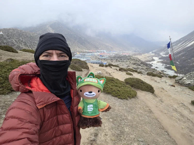 Nicholas holding Sumi overlooking Dingboche