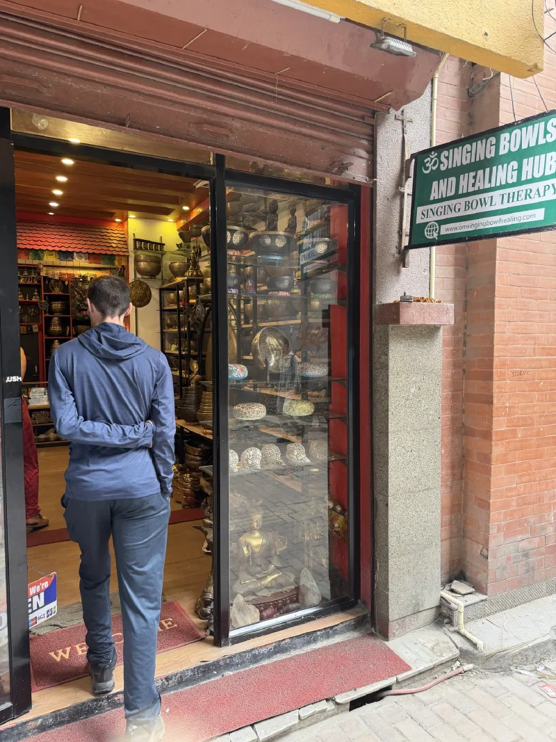 Nicholas entering a singing bowl shop in Kathmandu
