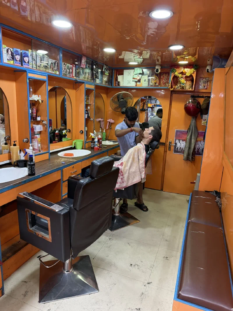 Nicholas getting a shave in a Kathmandu barbershop