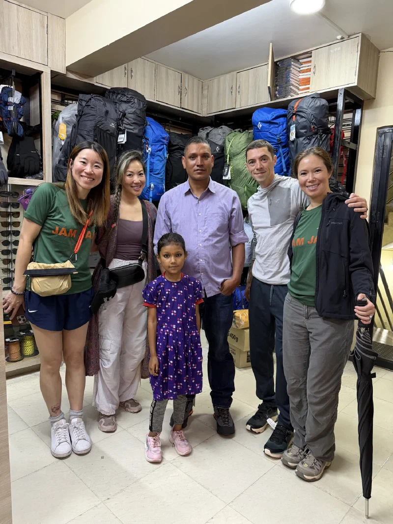 The group posing with Manoj and his new shoes outside the store