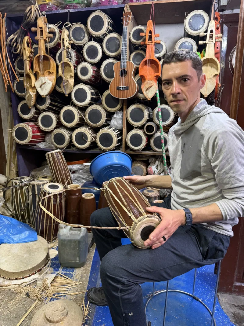 Nicholas and Ashish playing drums together in the shop