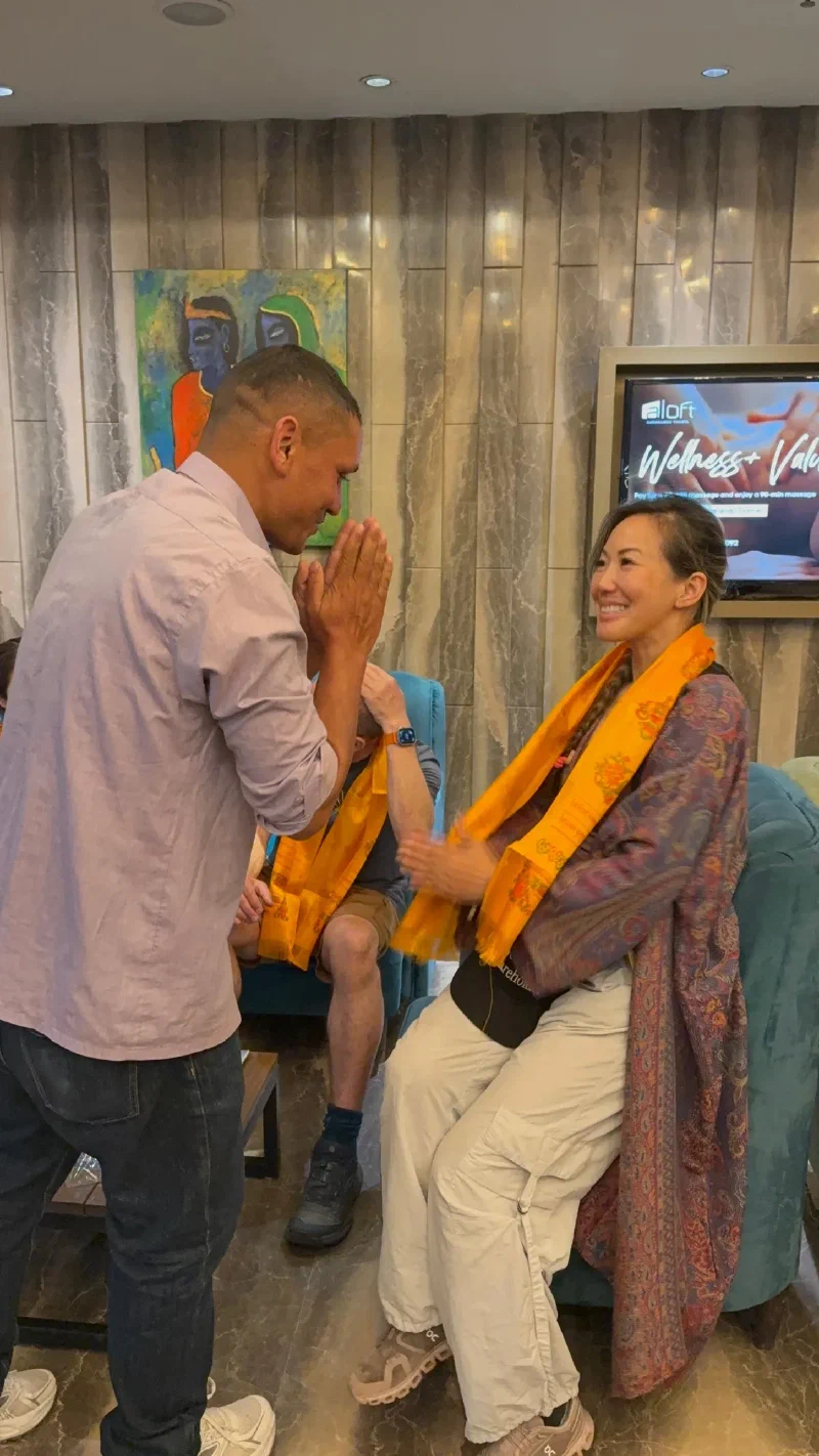 Manoj presenting a scarf to Po On at the hotel