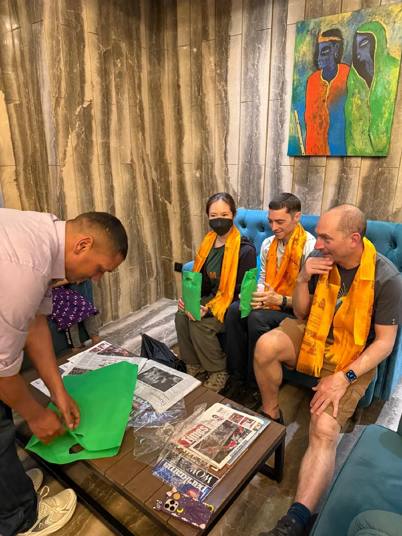 The group wearing their new scarves from Manoj