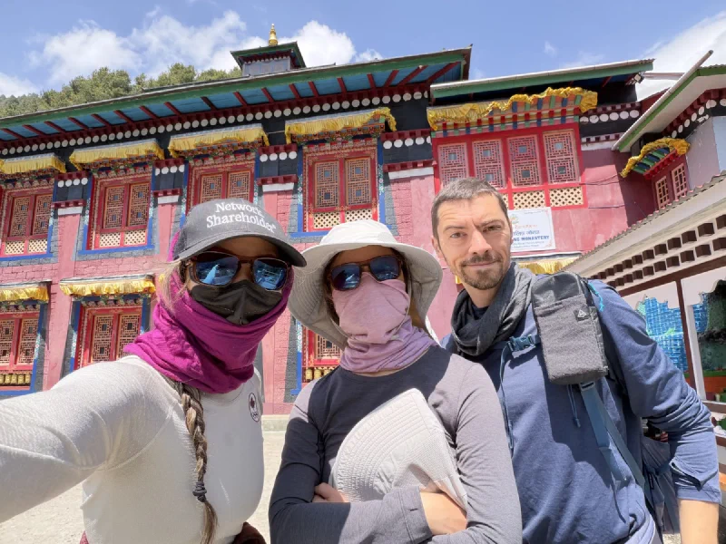 Nicholas, Pokin, and Po On taking a selfie in front of the ornate monastery building