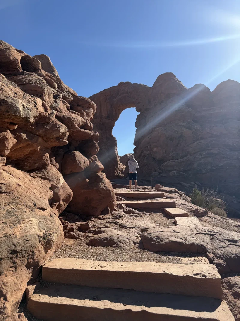 Stone steps leading up to Turret Arch with a figure standing beneath the opening