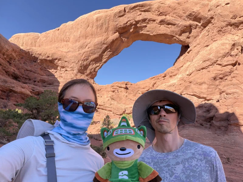 Pokin in sunglasses and a blue neck gaiter, Sumi in the middle, Nicholas in a wide hat, with South Window arching overhead